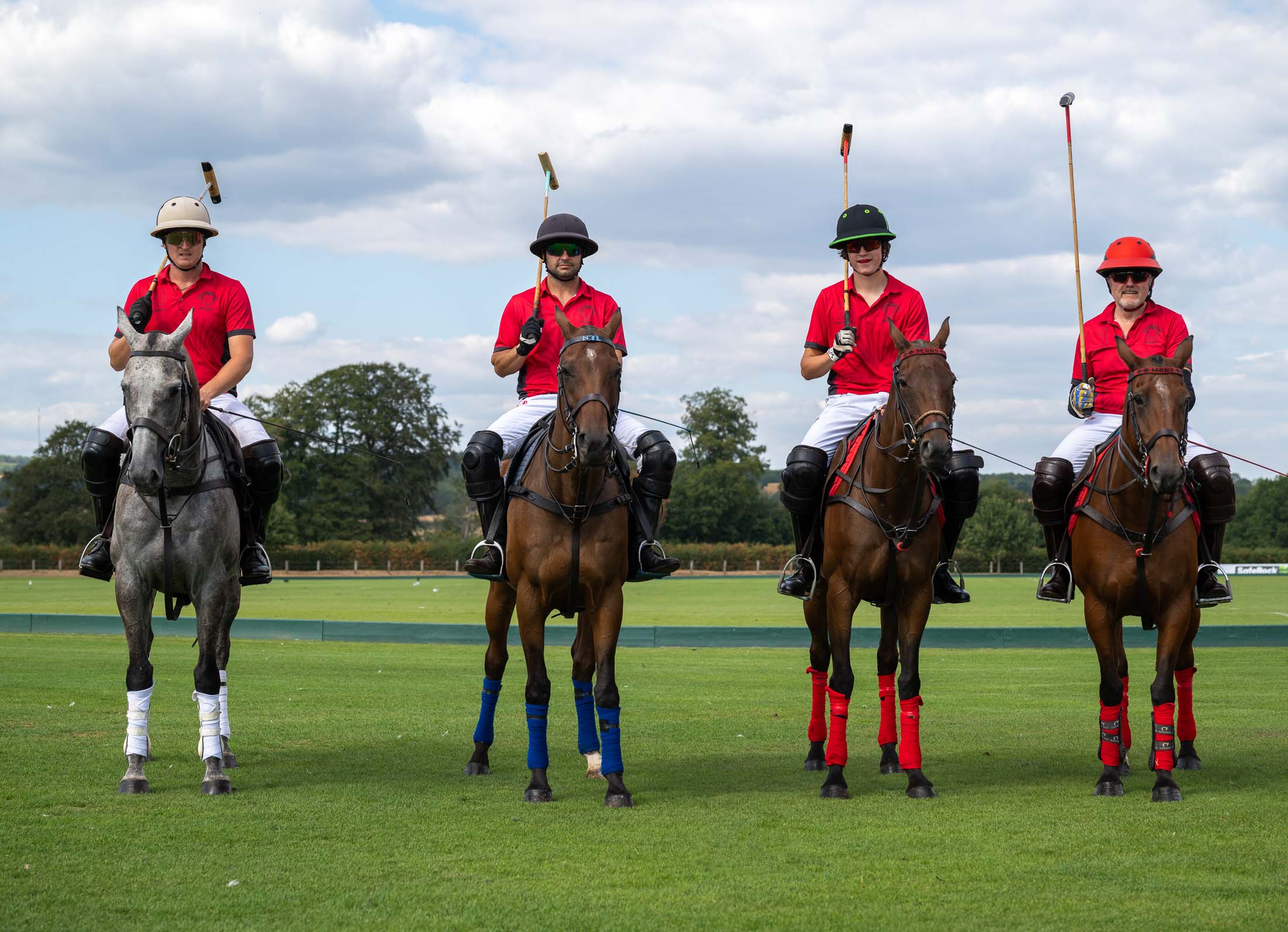 The Mono Polo team lined up on horseback, mallets raised
